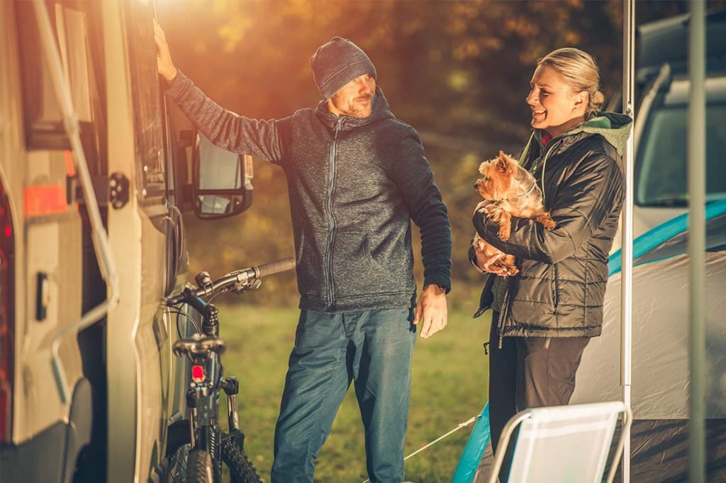 Couple in caravan park with dog